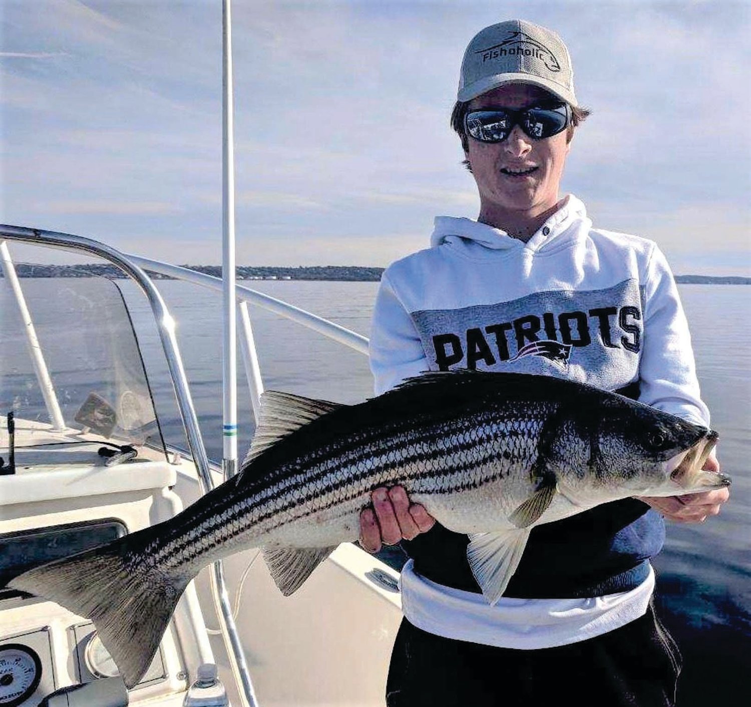 BASS BITE GOOD: Joe Earley caught this 30-inch striped bass in the northern part of Mt. Hope Bay when fishing with his father this weekend. Joe said, “The bass were schooling on the surface and we caught four casting SP Minnows to them.”